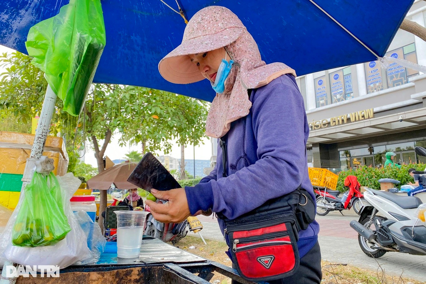 Chị Lý trang bị khẩu trang, áo khoác, nước uống liên tục tránh kiệt sức, ngất xỉu khi làm việc ngoài trời cả ngày (Ảnh: Nguyễn Vy).