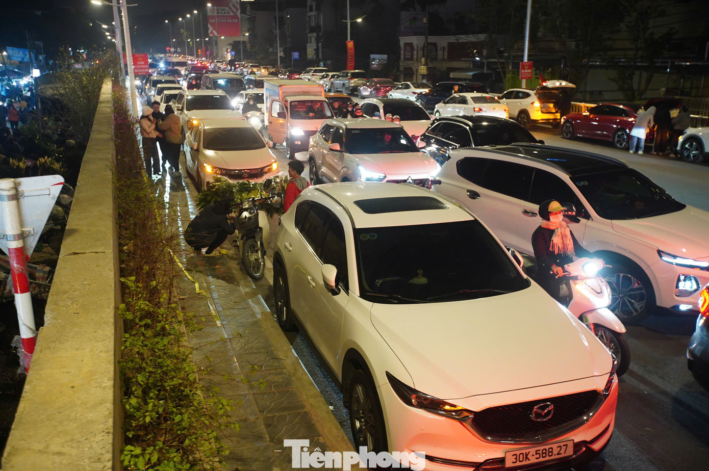 Con đường hướng vào chợ Quảng Bá tắc nghẽn. Những ngày cận Tết, lực lượng chức năng luôn túc trực tại khu vực này để điều tiết, phân luồng giao thông.