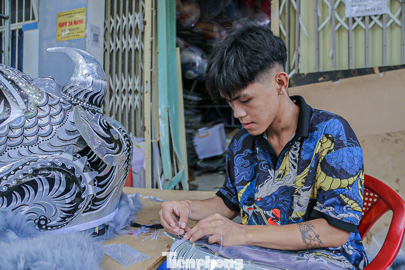 Anh Lương Sơn Hải đang chăm chú lên lông cho lân để hoàn thành sản phẩm bàn giao cho khách.