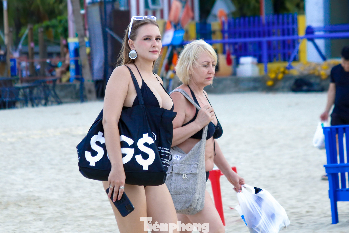 Nhiều du khách nước ngoài thích thú dạo trên bãi biển trong ngày hè oi bức, tận hưởng không khí trong lành.