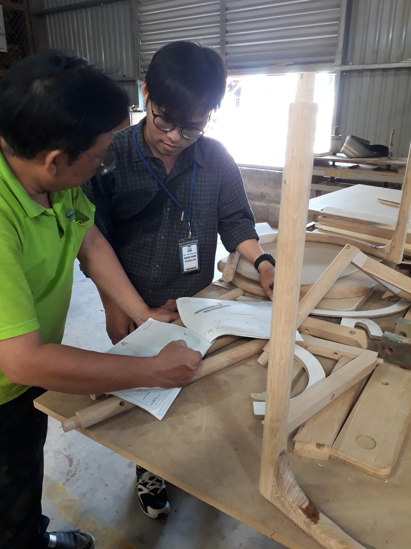 Duy Khánh (phải) làm việc như một nhân viên nhà máy với sự hướng dẫn của các kỹ thuật viên.