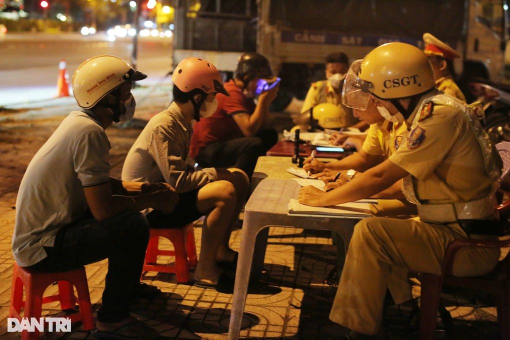 Ông H.V.T. (nón trắng) và N.V.T. (nón hồng) bị CSGT lập biên bản (Ảnh: An Huy).