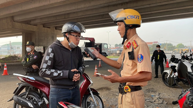 Một người điều khiển xe máy bị kiểm tra nồng độ cồn khi lưu thông qua chốt Một người điều khiển xe máy bị kiểm tra nồng độ cồn khi lưu thông qua chốt