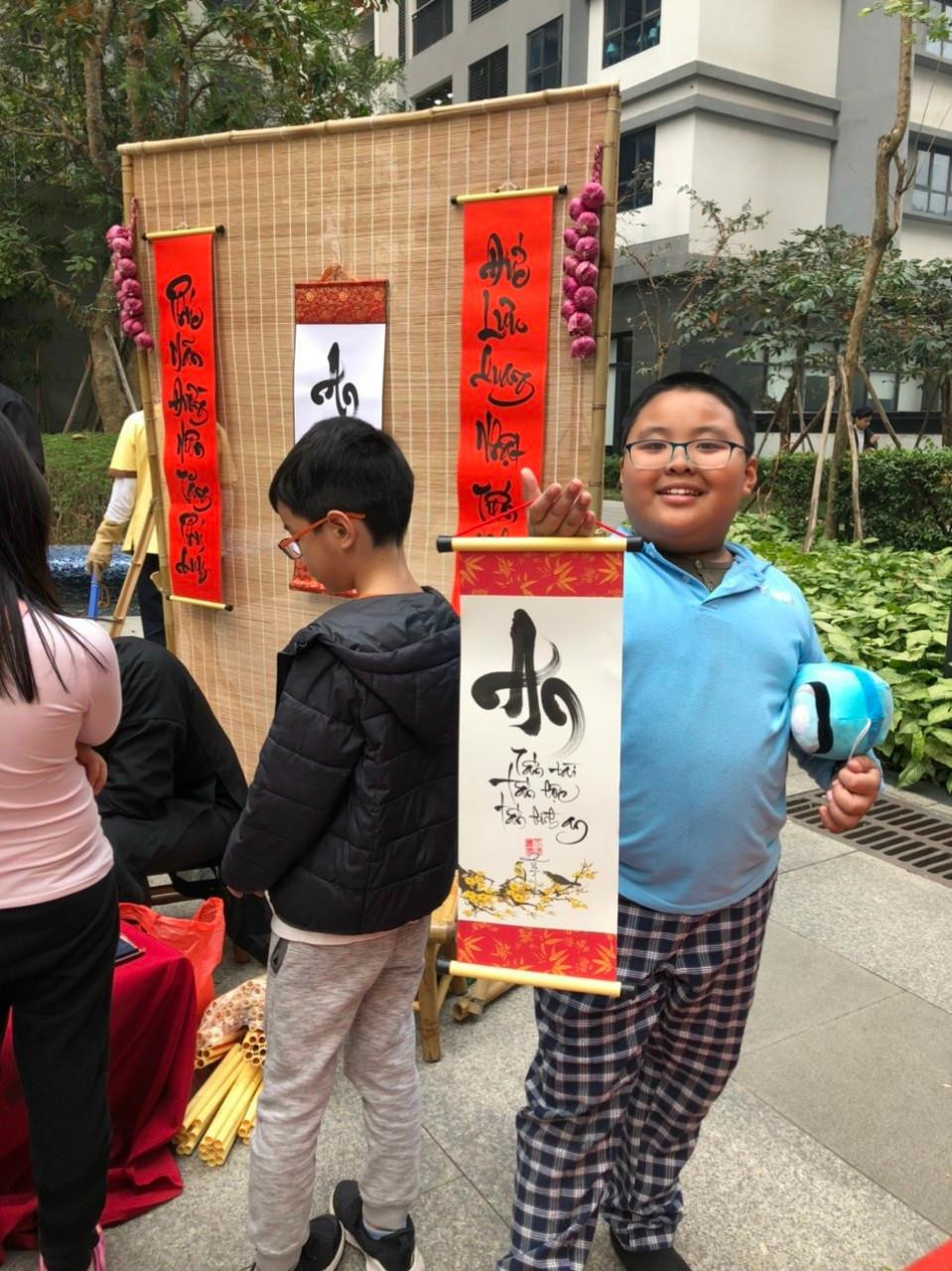 Niềm vui của các em nhỏ khi được "ông đồ" Tuấn tặng chữ.