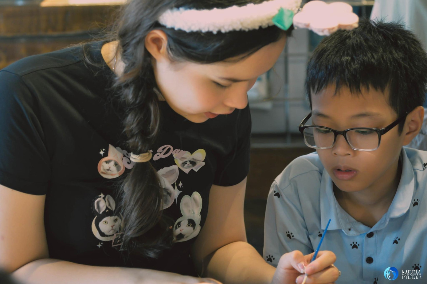 Maia hướng dẫn các em nhỏ trong workshop Phiên Tú hoàn thành sản phẩm nghệ thuật.
