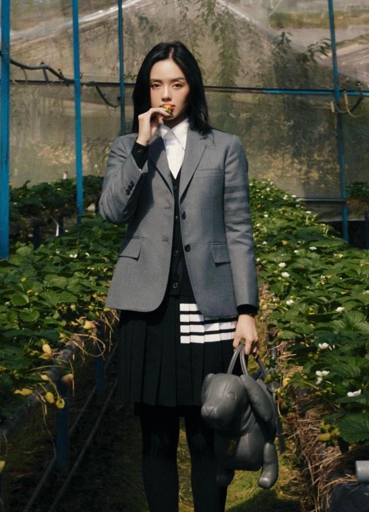 "Cô Em Trendy" biến hình thành quý cô thời thượng với vest xám, chân váy và vớ dài. Điểm nhấn của outfit nằm ở chiếc túi xách cực "quái", tạo nên tổng thể cá tính, thời thượng.