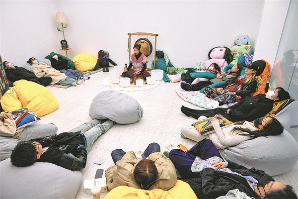 Khách hàng tận hưởng khoảnh khắc thiền định và chữa bệnh bằng âm thanh kéo dài hai giờ do Kong Yi (giữa) ở Thâm Quyến, Quảng Đông ̣(Trung Quốc) hướng dẫn.