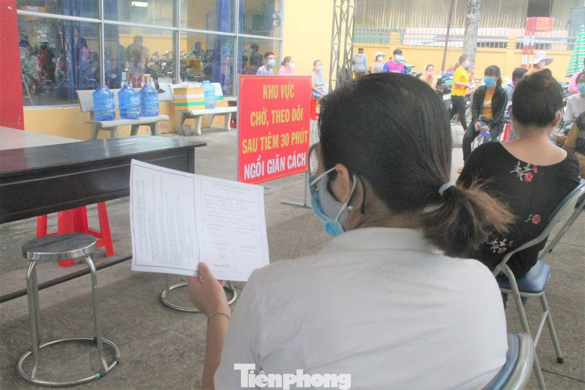 Người dân tranh thủ thời gian chờ sau tiêm để kiểm tra lại thông tin Người dân tranh thủ thời gian chờ sau tiêm để kiểm tra lại thông tin