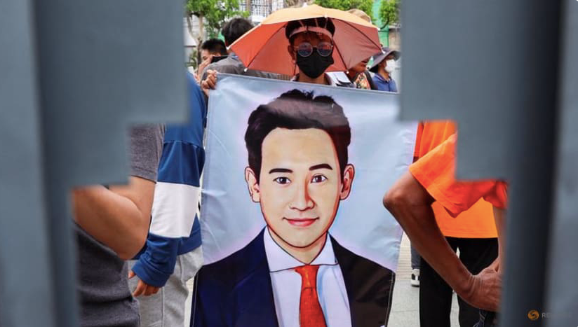 Một người ủng hộ cầm banner in phác hoạ chân dung lãnh đạo đảng Tiến bước Pita Limjaroenrat ở Bangkok ngày 19/7. (Ảnh: Reuters)