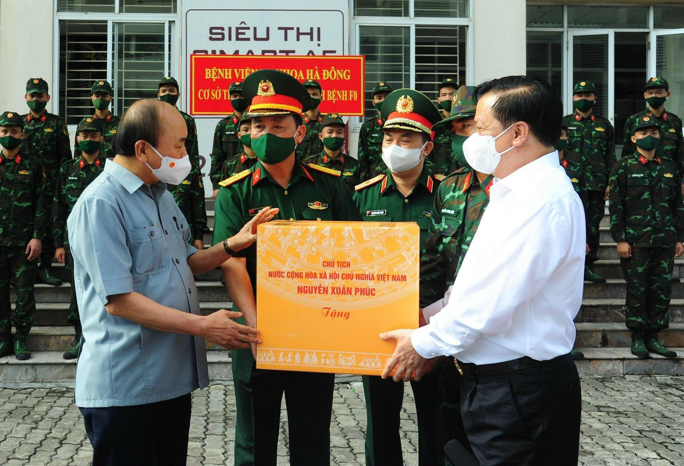 Chủ tịch nước Nguyễn Xuân Phúc, Bí thư Thành ủy Hà Nội Đinh Tiến Dũng tặng quà các đơn vị quân đội làm nhiệm vụ tại cơ sở thu dung điều trị bệnh nhân COVID-19 ở Khu nhà ở sinh viên Pháp Vân - Tứ Hiệp. Ảnh: Nguyễn Thành