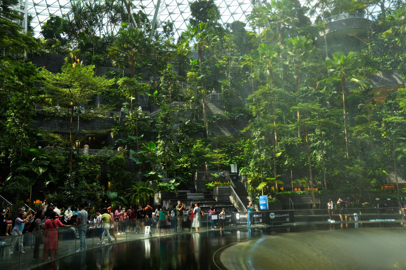 Không gian chủ đạo bao quanh thác nước của Jewel Changi là khu vườn nhiệt đới với khoảng 3.000 cây xanh, ghế ngồi của hành khách được bố trí bậc thang bên cạnh những tiểu cảnh nhỏ.