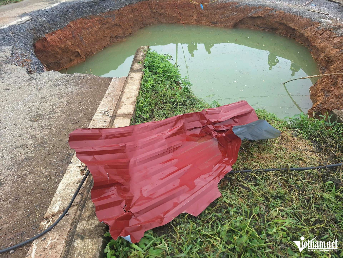 Tấm tôn chắn hố sụt lún bị biến dạng sau vụ tai nạn. Tấm tôn chắn hố sụt lún bị biến dạng sau vụ tai nạn.