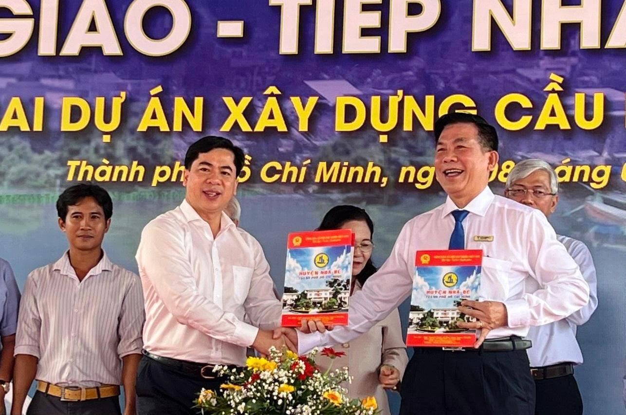 Lãnh đạo UBND huyện Nhà Bè và Trưởng Ban Quản lý dự án đầu tư xây dựng các công trình giao thông TPHCM Lương Minh Phúc (phải) thực hiện thủ tục bàn giao mặt bằng thi công Lãnh đạo UBND huyện Nhà Bè và Trưởng Ban Quản lý dự án đầu tư xây dựng các công trình giao thông TPHCM Lương Minh Phúc (phải) thực hiện thủ tục bàn giao mặt bằng thi công