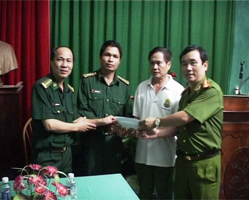 Đại tá Trần Đức Việt, Phó giám đốc, Thủ trưởng Cơ quan điều tra Công an tỉnh Quảng Trị (bìa phải) và Đại tá Nguyễn Đình Hà, Chỉ huy phó Bộ đội biên phòng tỉnh Quảng Trị (bìa trái) trao thưởng nóng cho lực lượng trực tiếp phá án - Ảnh: Thành Nam