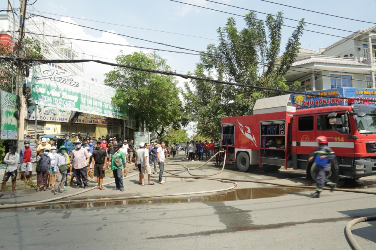 Hàng trăm người dân theo dõi vụ cháy từ bên ngoài hiện trường.