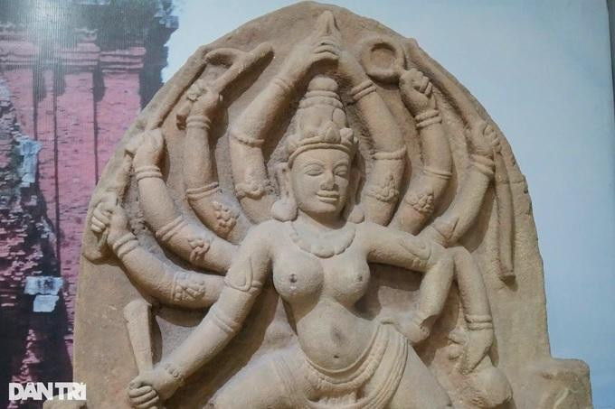 Tác phẩm điêu khắc được thể hiện hình tượng một vị nữ thần, có nhiều tay đang đứng trong tư thế múa trong khung hình vòm cung nhọn. Đây là loại hình điêu khắc dùng trang trí bên trên cửa ra vào của ngôi tháp. Phù điêu thể hiện nữ thần Mahishasuramardini 10 tay, gồm 2 tay chính và 8 tay phụ, trên mỗi tay cầm một vật tế khí.