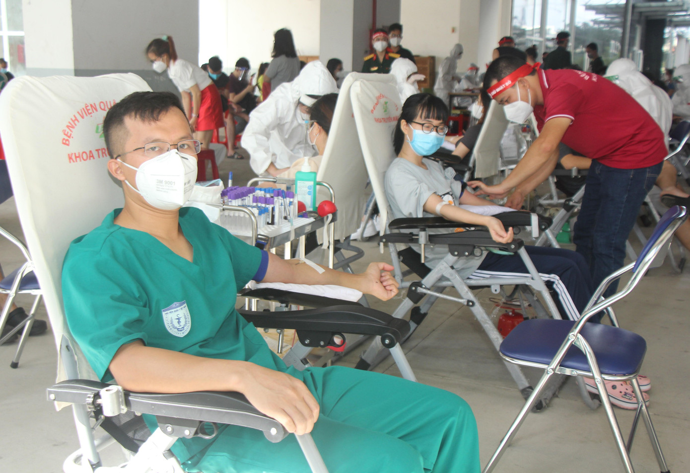 Trong khi đó, anh Nguyễn Thế Thuận (25 tuổi, học viên Học viện Quân y, Hà Nội) hiến máu trong khi đang tham gia công tác chống dịch trên địa bàn quận 8. Hiện anh Thuận là thành viên Tổ quân y lưu động 183 thuộc phường 6, quận 8 và trực chốt cùng đồng đội ngay tại chung cư này. "Những năm qua, bình thường cứ đủ thời gian duy trì thì mình đều hiến và hiện bản thân cũng đã đủ điều kiện cho phép, lúc này lại có đợt diễn ra ngay tại nơi mình hoạt động nên tham gia hiến luôn. Nguồn máu khắp nơi hiện đang khan hiếm do ảnh hưởng của dịch bệnh, do đó khi có dịp giúp được thì mình sẵn sàng”, anh Thuận bộc bạch. Tính luôn lần này, anh Thuận đã có tổng cộng 14 lần hiến máu. Trong suốt quãng đường sinh viên vừa qua, Thuận tham gia hiến ở Học viện Quân y, Bệnh viện 103, Viện Huyết học truyền máu Trung ương, bình quân mỗi năm 3 lần - Ảnh: Ngô Tùng Trong khi đó, anh Nguyễn Thế Thuận (25 tuổi, học viên Học viện Quân y, Hà Nội) hiến máu trong khi đang tham gia công tác chống dịch trên địa bàn quận 8. Hiện anh Thuận là thành viên Tổ quân y lưu động 183 thuộc phường 6, quận 8 và trực chốt cùng đồng đội ngay tại chung cư này. "Những năm qua, bình thường cứ đủ thời gian duy trì thì mình đều hiến và hiện bản thân cũng đã đủ điều kiện cho phép, lúc này lại có đợt diễn ra ngay tại nơi mình hoạt động nên tham gia hiến luôn. Nguồn máu khắp nơi hiện đang khan hiếm do ảnh hưởng của dịch bệnh, do đó khi có dịp giúp được thì mình sẵn sàng”, anh Thuận bộc bạch. Tính luôn lần này, anh Thuận đã có tổng cộng 14 lần hiến máu. Trong suốt quãng đường sinh viên vừa qua, Thuận tham gia hiến ở Học viện Quân y, Bệnh viện 103, Viện Huyết học truyền máu Trung ương, bình quân mỗi năm 3 lần - Ảnh: Ngô Tùng