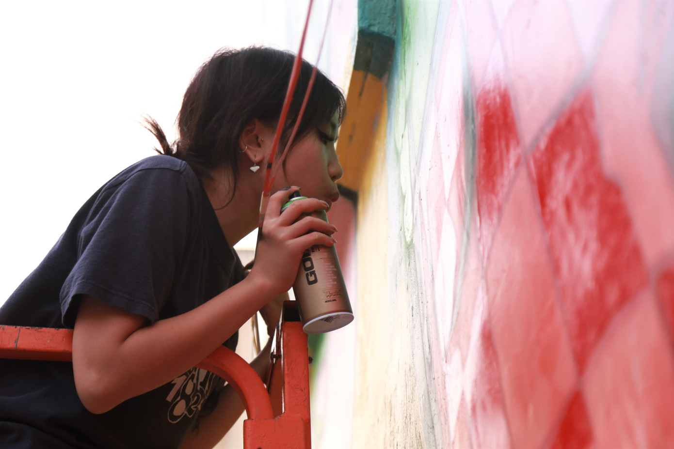 Một cô gái mới học vẽ tranh đường phố cũng tham gia thực hiện bức tranh tường.