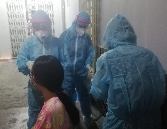 Lực lượng y tế lấy mẫu xét nghiệm các trường hợp tiếp xúc với ca nghi ngờ mắc COVID-19 ở quận 11. Ảnh HCDC