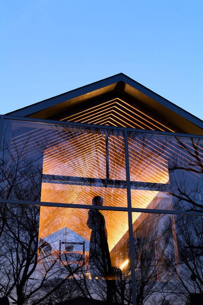 Điểm nhấn của ngôi nhà là không gian phòng khách mở ở tầng 2 có mái đầu hồi với xà nhà lộ ra ngoài. Phần ban công phía trước sử dụng toàn bộ kính một chiều để người trong nhà có thể hướng tầm nhìn ra ngoài cũng như cho phép khung cảnh thiên nhiên bên ngoài ẩn hiện vào trong nhà.