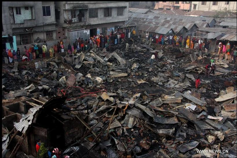 Người dân khu ổ chuột Mohakhali, thủ đô Dhaka đứng nhìn quang cảnh còn lại sau đám cháy 