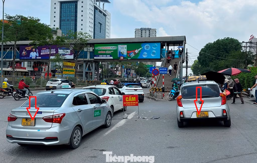 Hàng loạt taxi đeo biển taxi truyền thống (taxi hãng) và taxi công nghệ (chạy grab) đều che biển khi đứng bắt khách "chợ" (khách vẫy xe trên đường) trước cổng bệnh viện Bạch Mai.