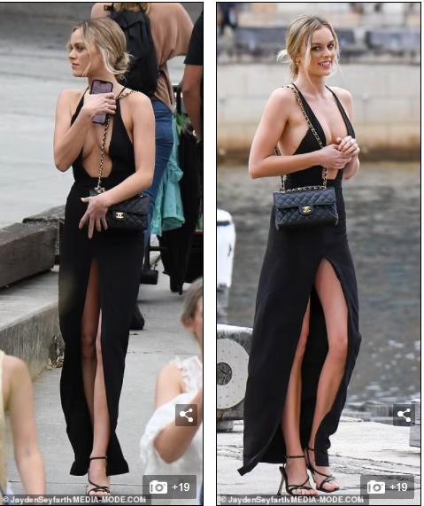 Tuy nhiên, chiếc váy của Madeline Holtznagel xẻ quá đà khiến chân dài 9x lộ gần hết vòng một trên phố và cô liên tục phải lấy tay kéo quai váy và che chắn.