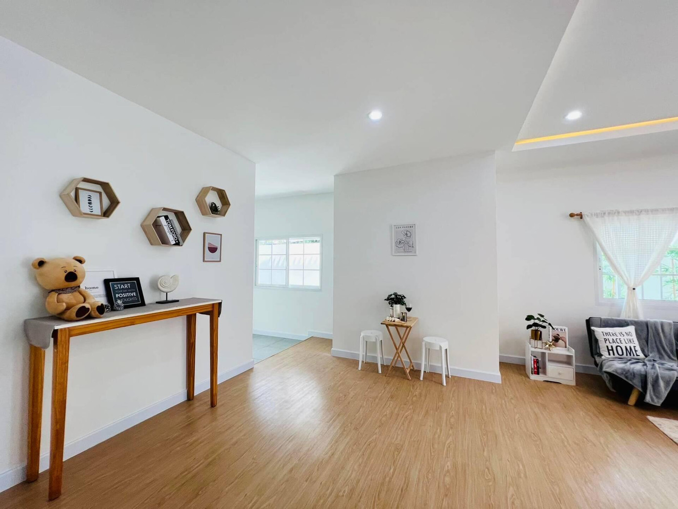 Tường màu trắng, sàn gỗ nâu kết hợp với nội thất gỗ ấm cúng.