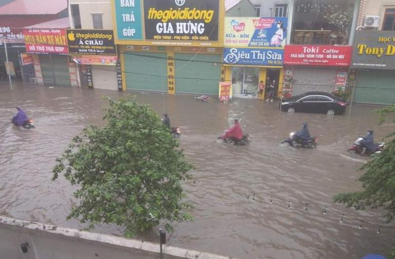 Người dân bì bõm lội nước trong cơn mưa (Ảnh: Facebook).