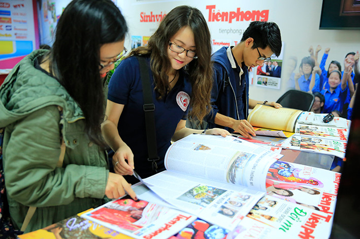 Độc giả trẻ đọc báo Tiền Phong số Tết. Ảnh: Hồng Vĩnh