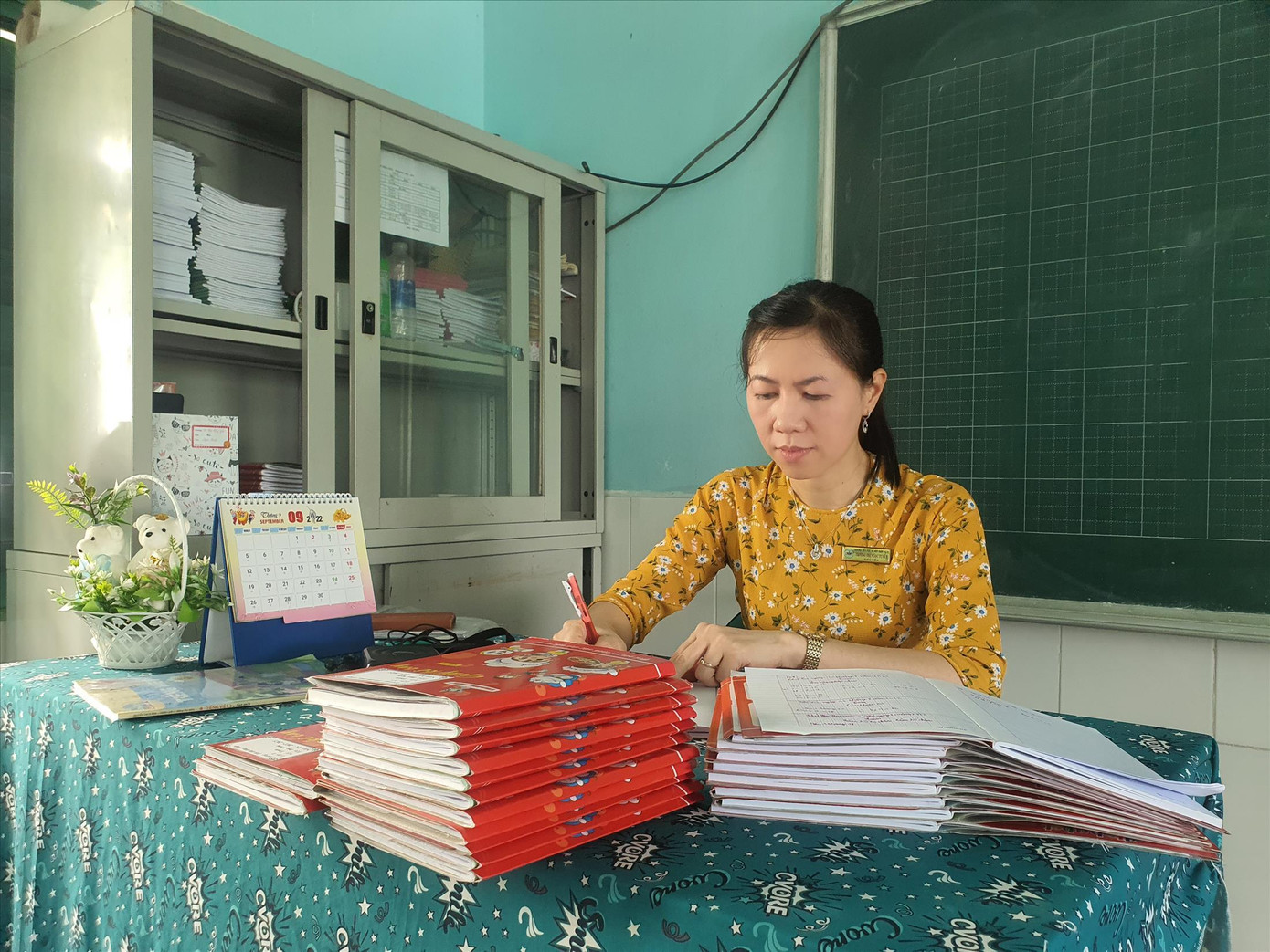 Giáo viên tranh thủ chấm bài trong giờ giải lao Ảnh: Nguyễn Dũng