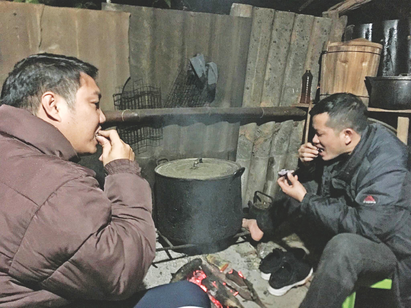 Tác giả và đồng nghiệp Hoàng Dương ngồi nướng khoai, hong khô quần áo sau một đêm khốc liệt theo chân đội buôn lậu ở biên giới Bình Liêu.