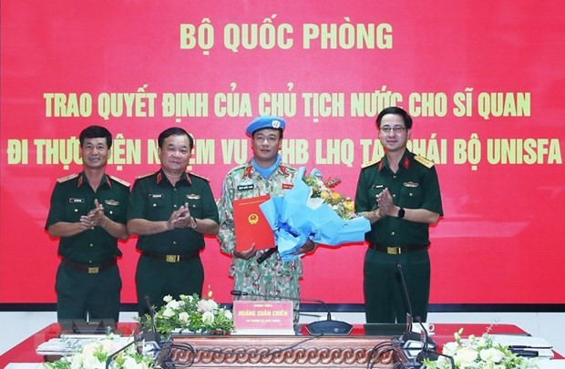 Thượng tướng Hoàng Xuân Chiến, Thứ trưởng Bộ Quốc phòng, trao quyết định của Chủ tịch nước cho Trung tá Đặng Quốc Tuấn đi thực hiện nhiệm vụ gìn giữ hòa bình Liên hợp quốc. Ảnh: ANTĐ.