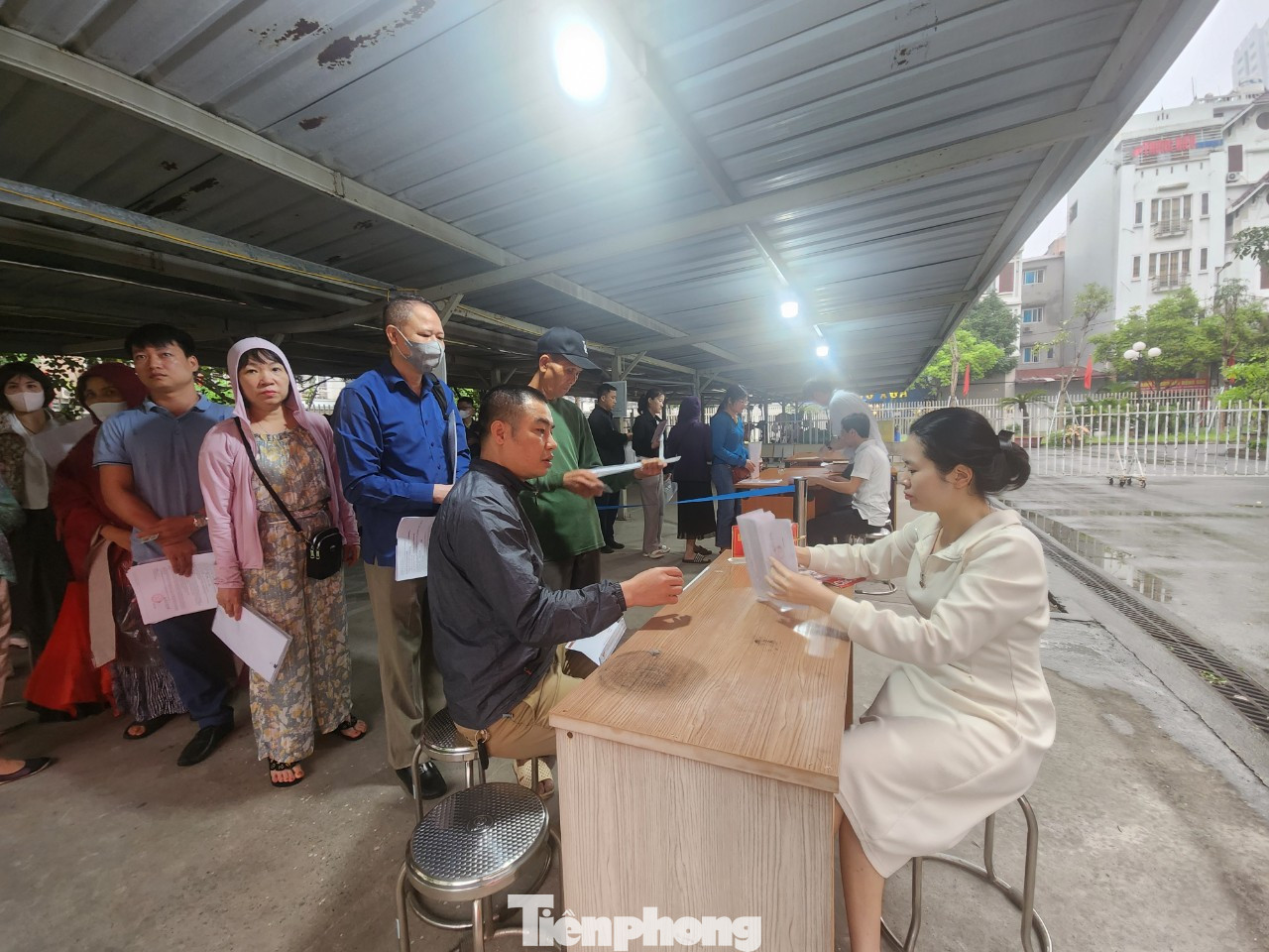 Cán bộ của đơn vị kiểm tra lại hồ sơ, giấy tờ của người dân trước khi vào lấy số. Cán bộ của đơn vị kiểm tra lại hồ sơ, giấy tờ của người dân trước khi vào lấy số.