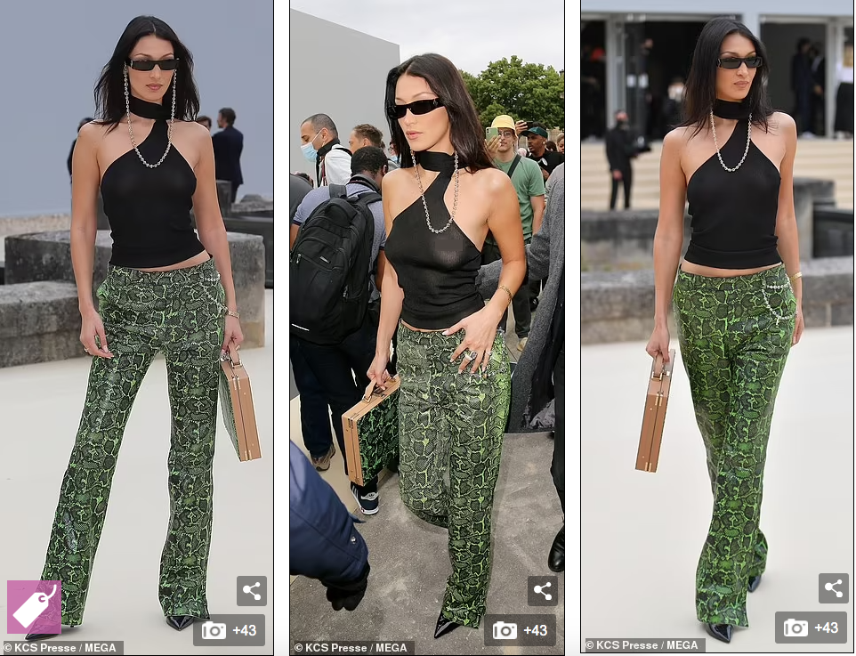 Người đẹp sinh năm 1996 mặc set đồ cá tính và táo bạo khi diện áo khoét vai, chất liệu mỏng tang và lộ trọn vòng một căng tròn. Quần xanh lá hoạ tiết da rắn với chiếc cặp phụ kiện "ton sur ton" tôn vẻ sành điệu.