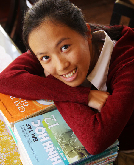 Nguyễn Kim Phượng với chồng sách dùng luyện thi tốt nghiệp và đại học, chỉ toàn sách giáo khoa - Ảnh: Mai Vinh