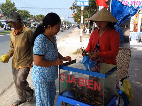 Chị Dân (phải) đang bán cua cho khách