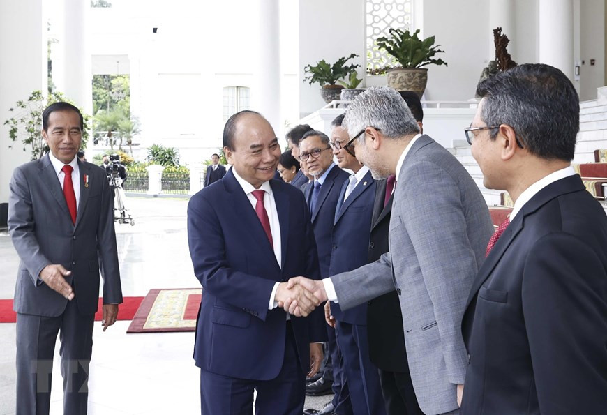 Tổng thống Joko Widodo giới thiệu các thành viên Đoàn đại biểu Indonesia với Chủ tịch nước Nguyễn Xuân Phúc. (Ảnh: Thống Nhất/TTXVN)