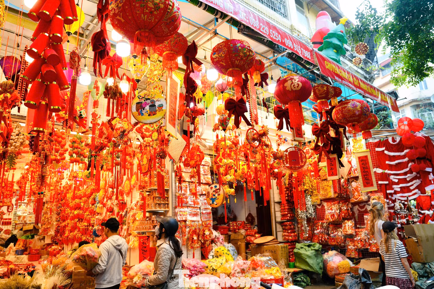 Các cửa hàng bày bán đa dạng đồ trang trí Tết như cành đào, pháo dây, bao lì xì, đèn lồng, câu đối...