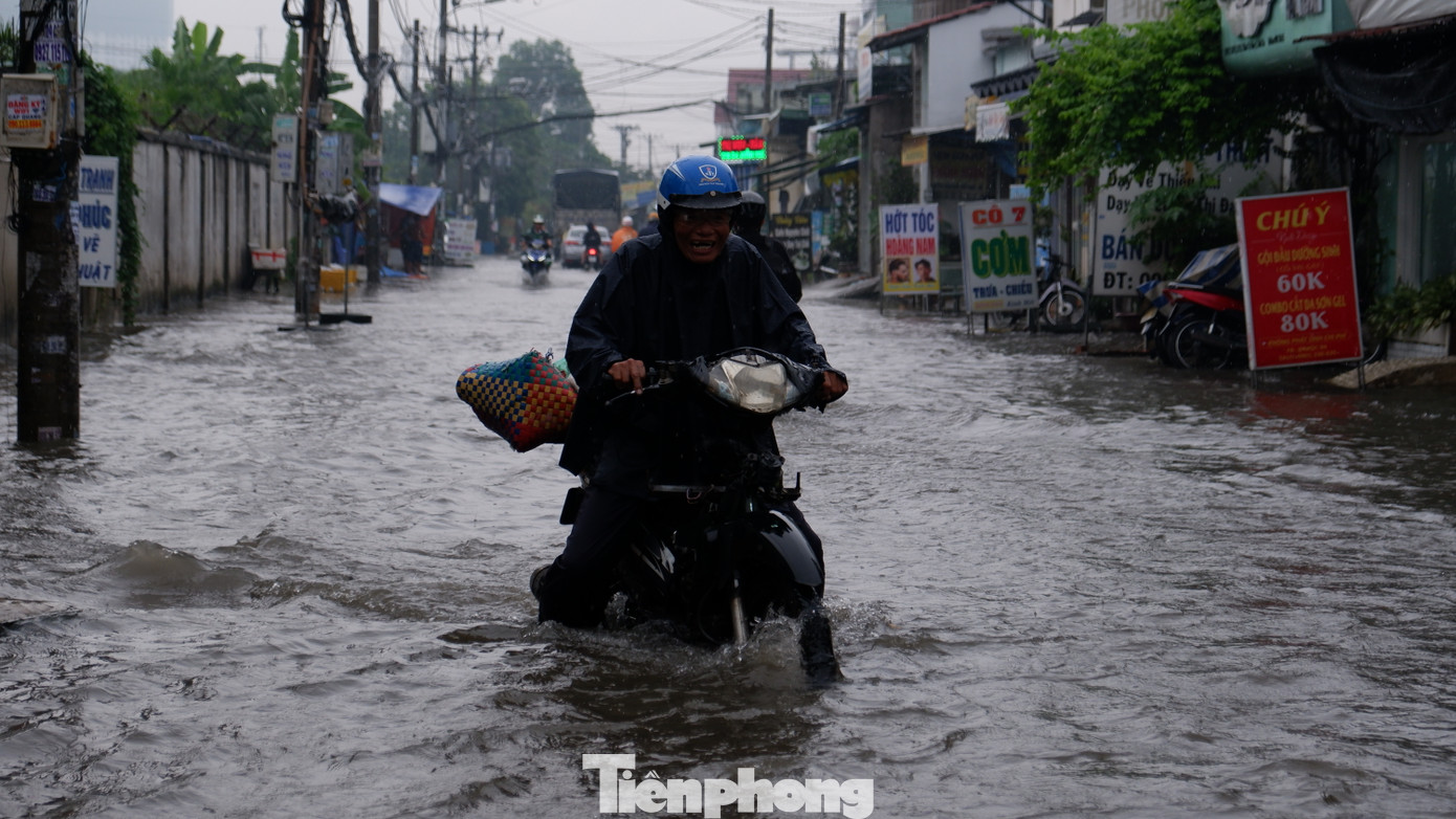 Người dân chật vật đi qua điểm ngập sâu. Người dân chật vật đi qua điểm ngập sâu.