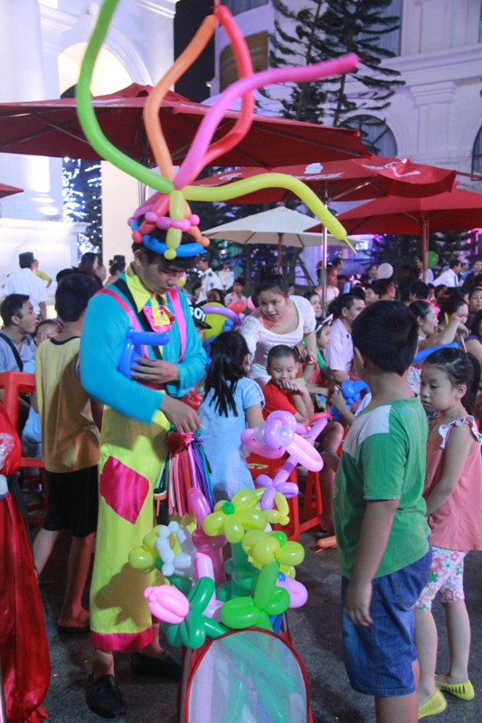 Bé thích thú với những món quà màu sắc do các chú hề trao tặng