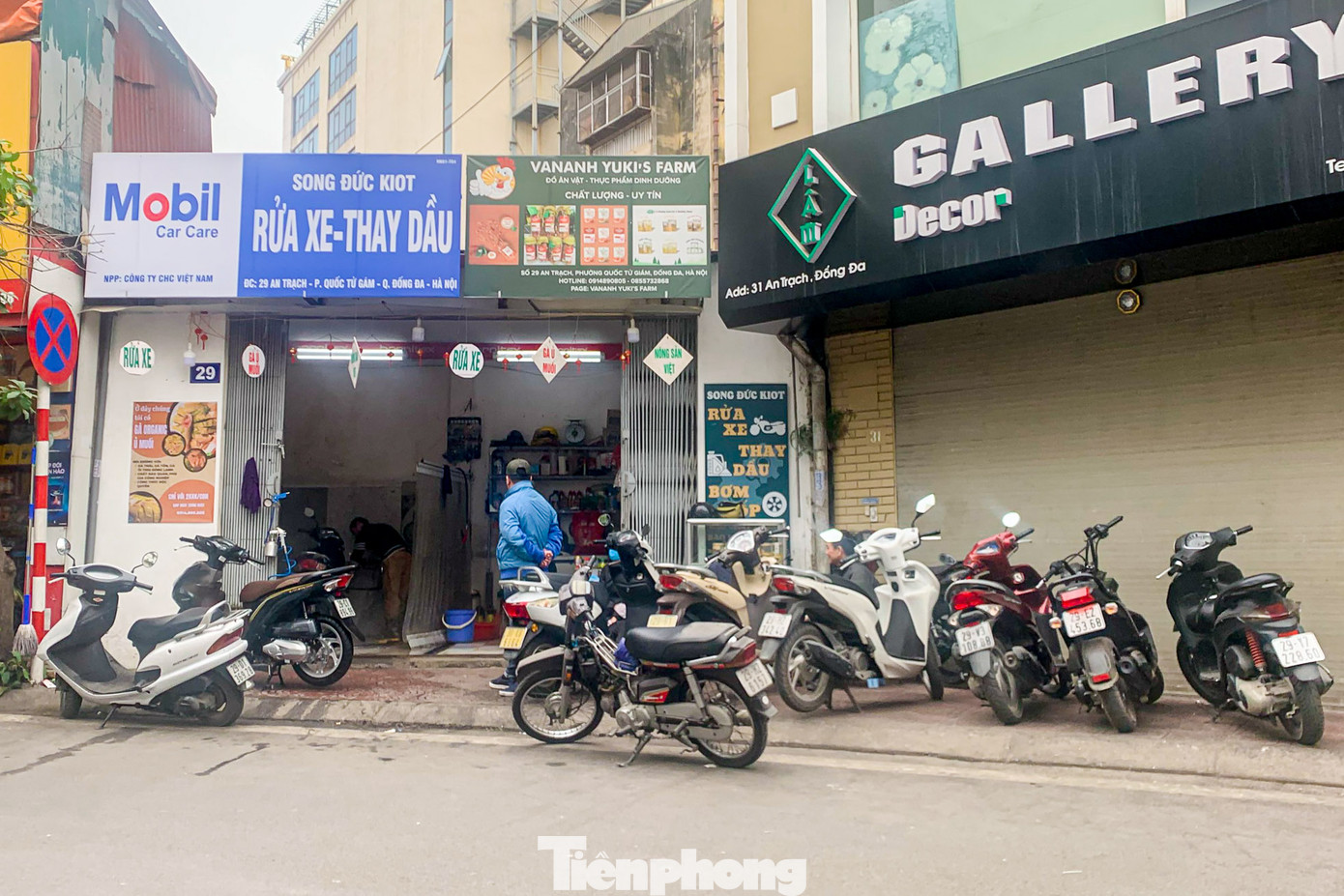 Xe máy xếp hàng trên vỉa hè chờ đến lượt trước một cửa hàng trên phố An Trạch.