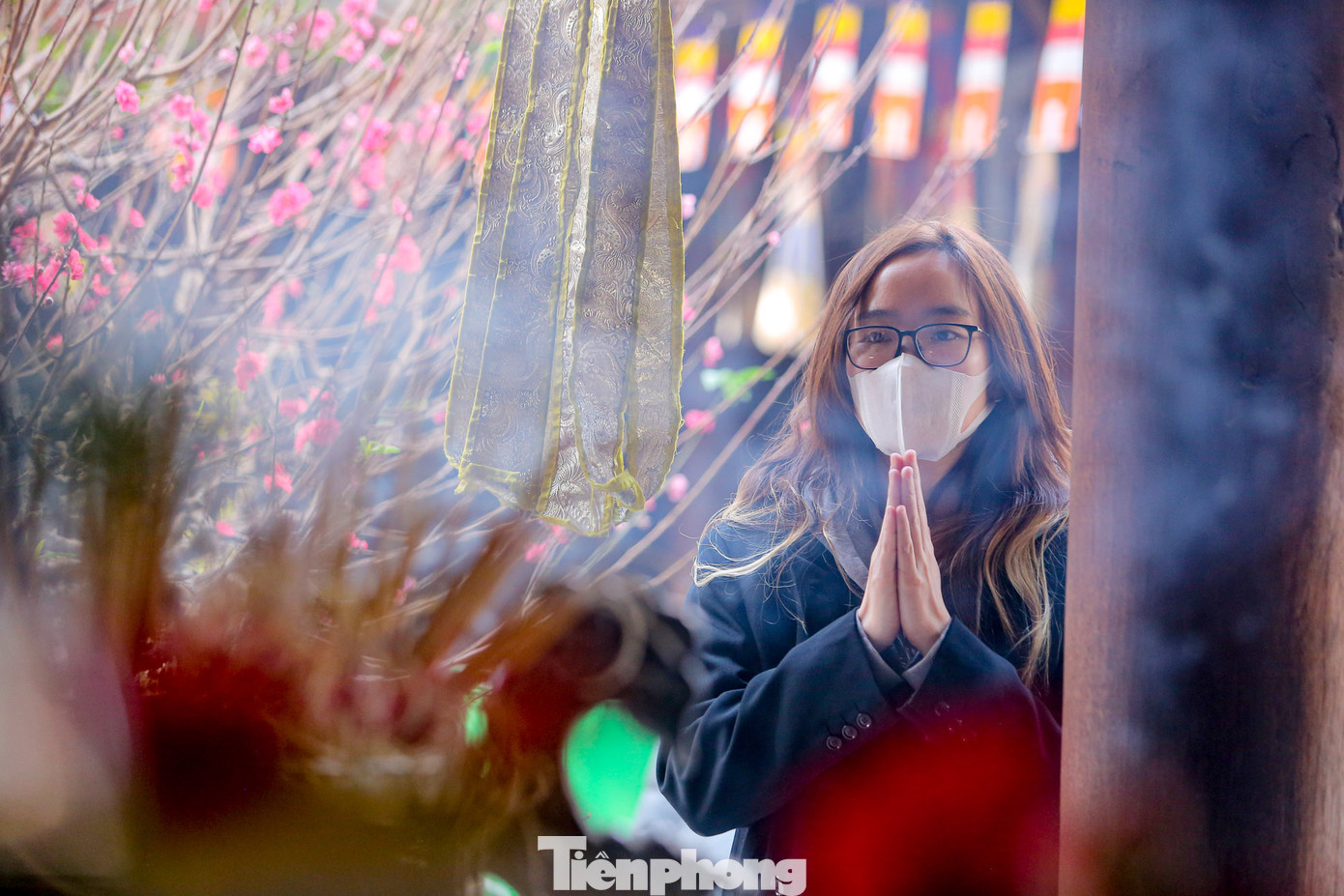 Sau làn khói hương kính lễ là những lời khấn thành tâm của một cô gái trẻ.