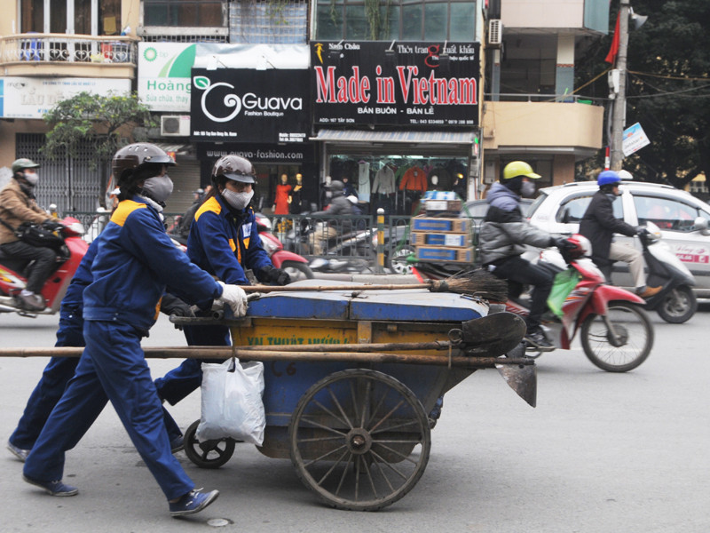 Những chị lao công vẫn miệt mài dọn rác trên các tuyến phố Hà Nội. Ảnh: Tuấn Nguyễn