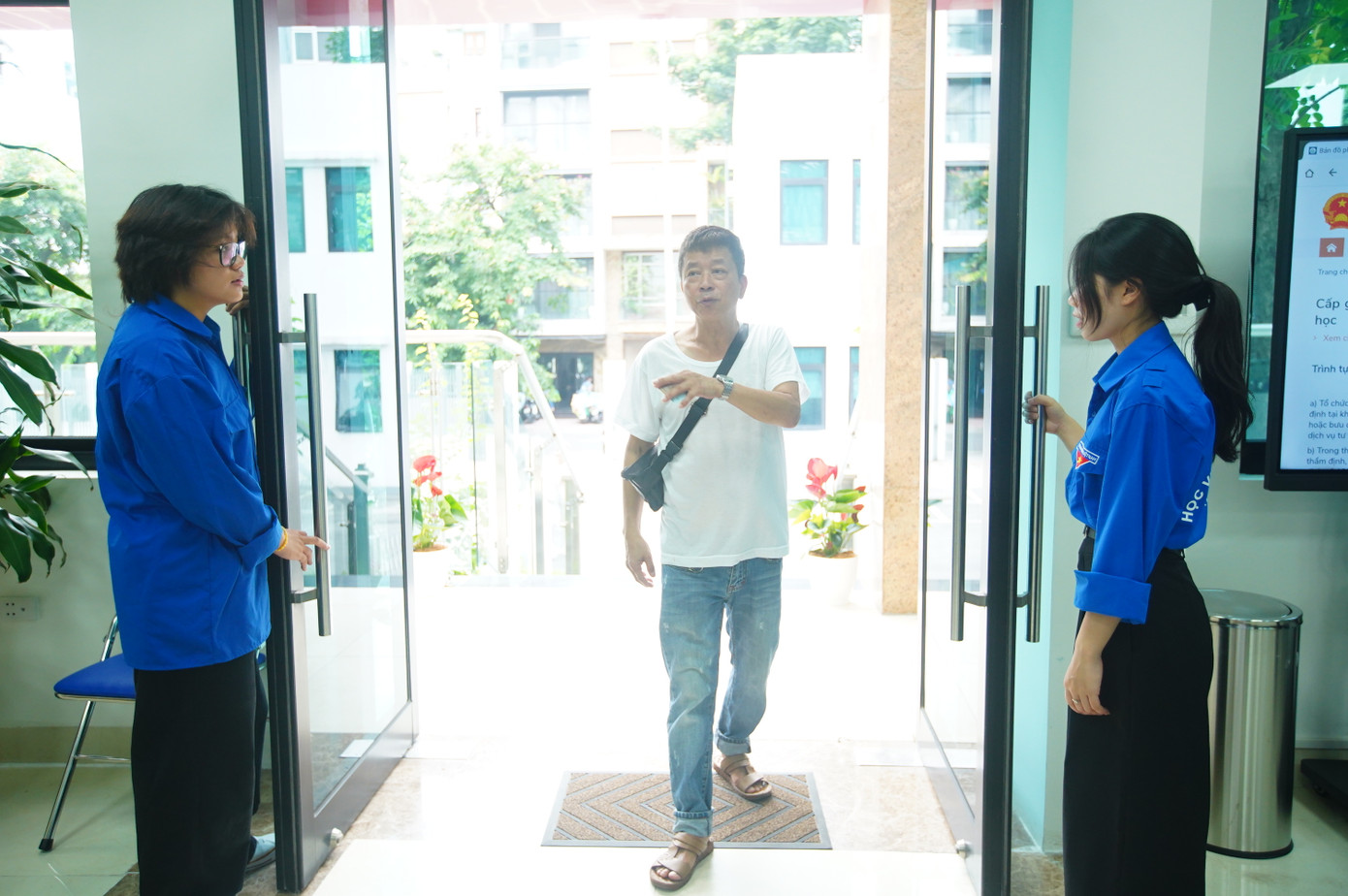 Đội thanh niên tình nguyện hỗ trợ người dân ngay từ cổng vào khu vực hành chính công.