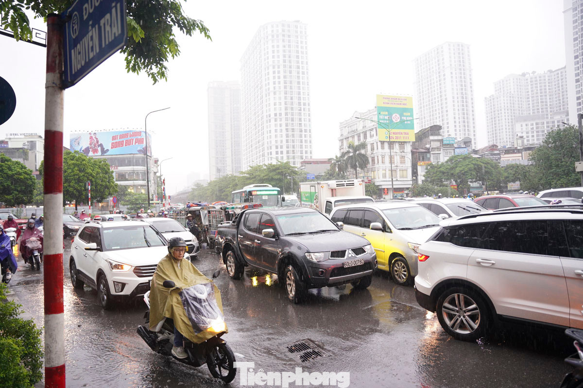 Người dân chật vật di chuyển trong mưa.