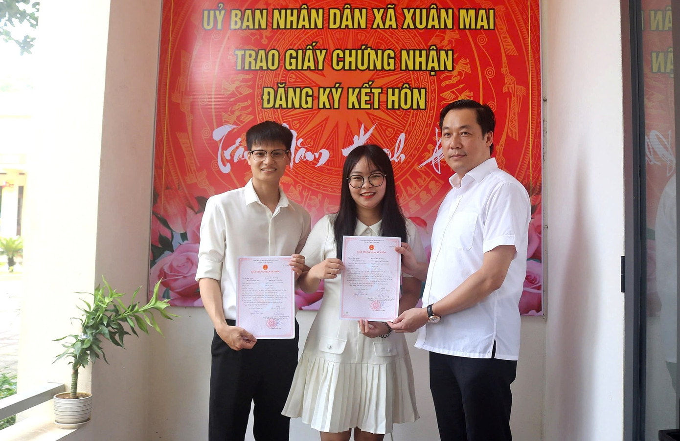 Chủ tịch UBND xã Xuân Mai Nguyễn Anh Đức trao Giấy chứng nhận đăng ký kết hôn cho công dân địa phương.