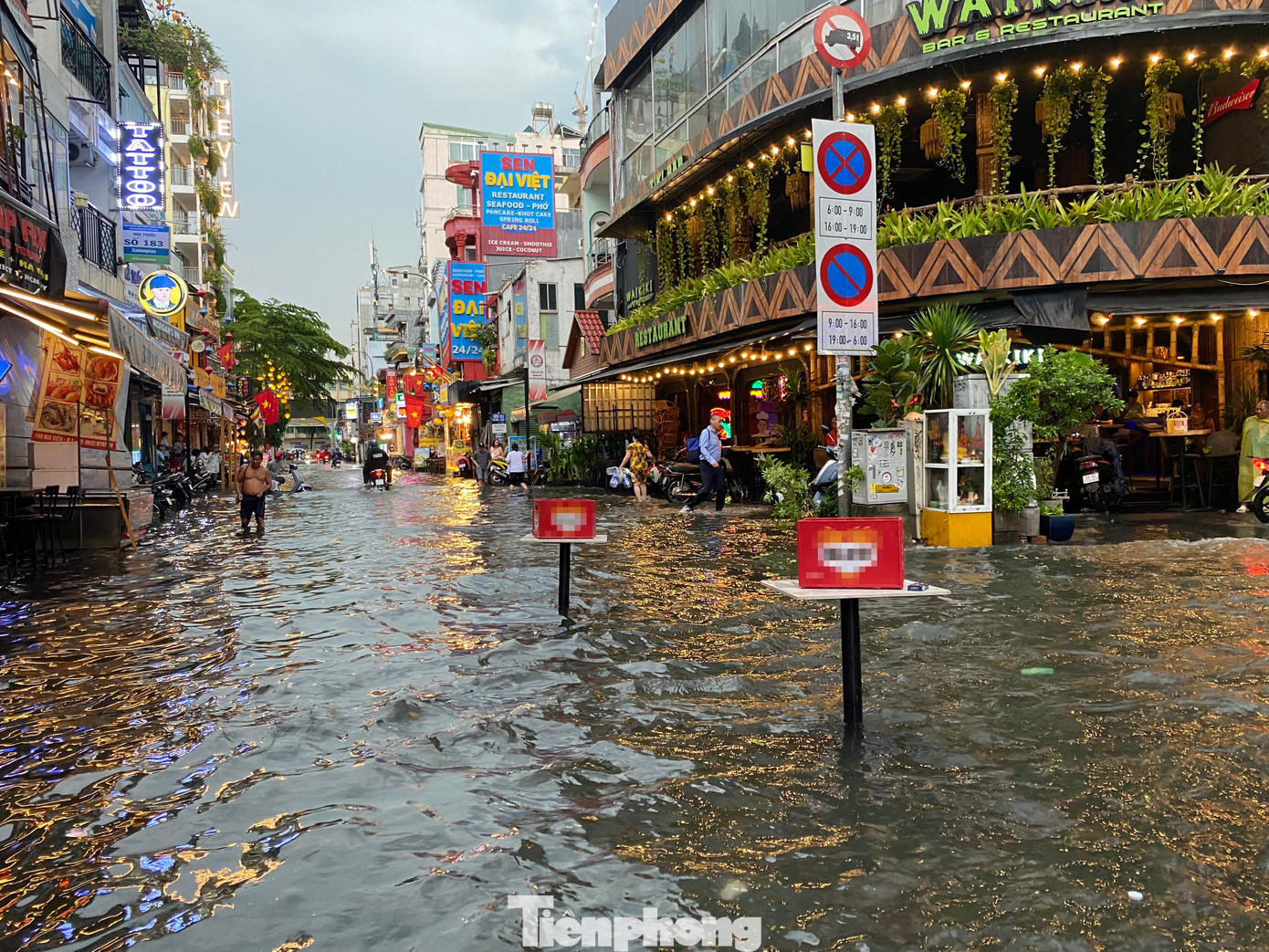 Một hàng quán trên &apos;phố Tây&apos; Bùi Viện đã đặt bàn ra giữa đường để cảnh báo điểm ngập sâu phía trước.