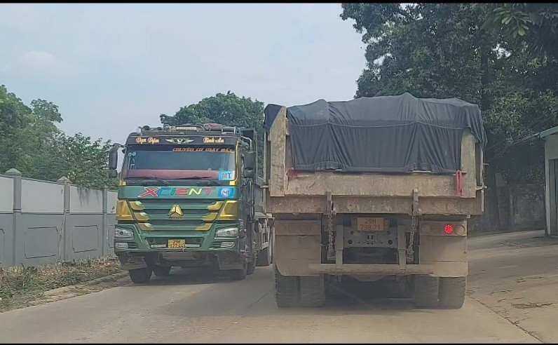 Những chiếc xe biển Hà Nội, Hòa Bình, trên cabin trưng biển như TT, Minh Dân, Hợp Nhất, TD, nhiều nhất là xe trưng biển MT nối đuôi nhau chờ lấy hàng. Tại khu vực gần mỏ đất, có một người điều tiết xe ra vào địa phận một khu quân sự. Những xe tải này lầm lũi vào rồi quay ra với thùng chất đầy đất.