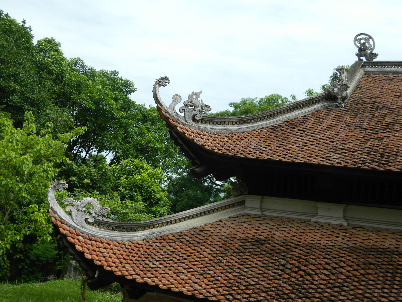 Trung đường có hai tầng mái cong, bốn vì kèo gỗ cấu trúc “giá chiêng chồng rường kẻ bẩy”, trang trí đề tài tứ linh, hình hoa lá, vân mây, rồng hóa.